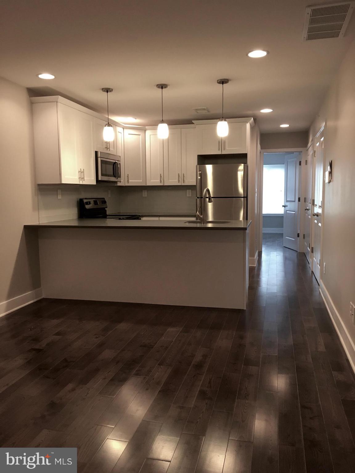 2341 West Thompson Street, Unit C Philadelphia, PA 19121 - Photo 2 of 13 a large kitchen with stainless steel appliances a large counter top