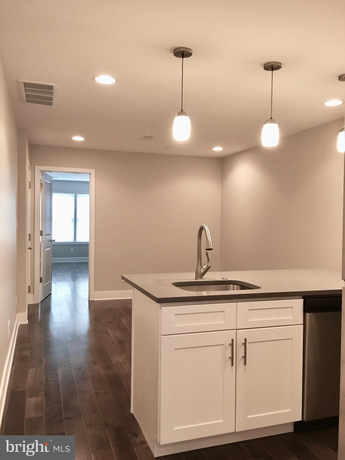 2341 West Thompson Street, Unit C Philadelphia, PA 19121 - Photo 3 of 13 a kitchen with a sink and chandelier