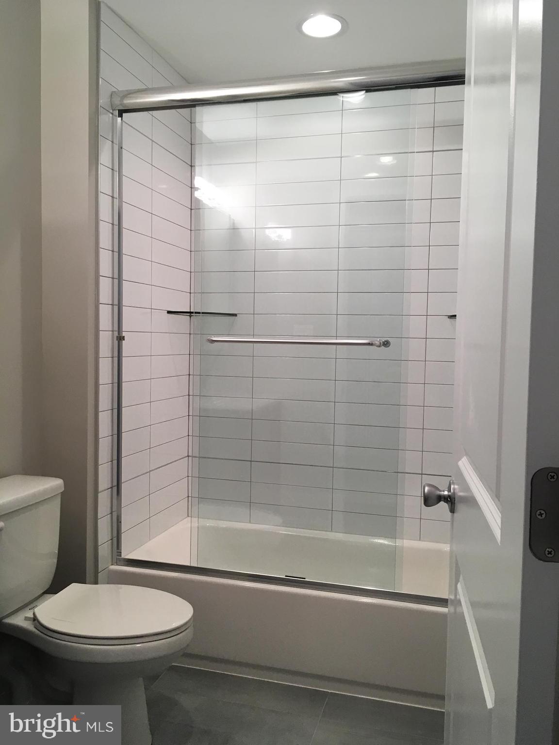 2341 West Thompson Street, Unit C Philadelphia, PA 19121 - Photo 9 of 13 a bathroom with a toilet and a shower