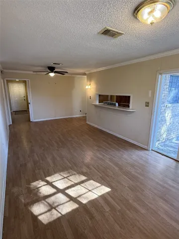 a view of a room with wooden floor and natural light