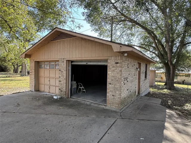 a view of a house with a yard and garage