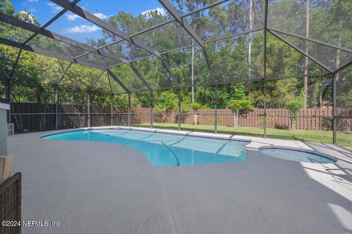 a view of a backyard with a swimming pool