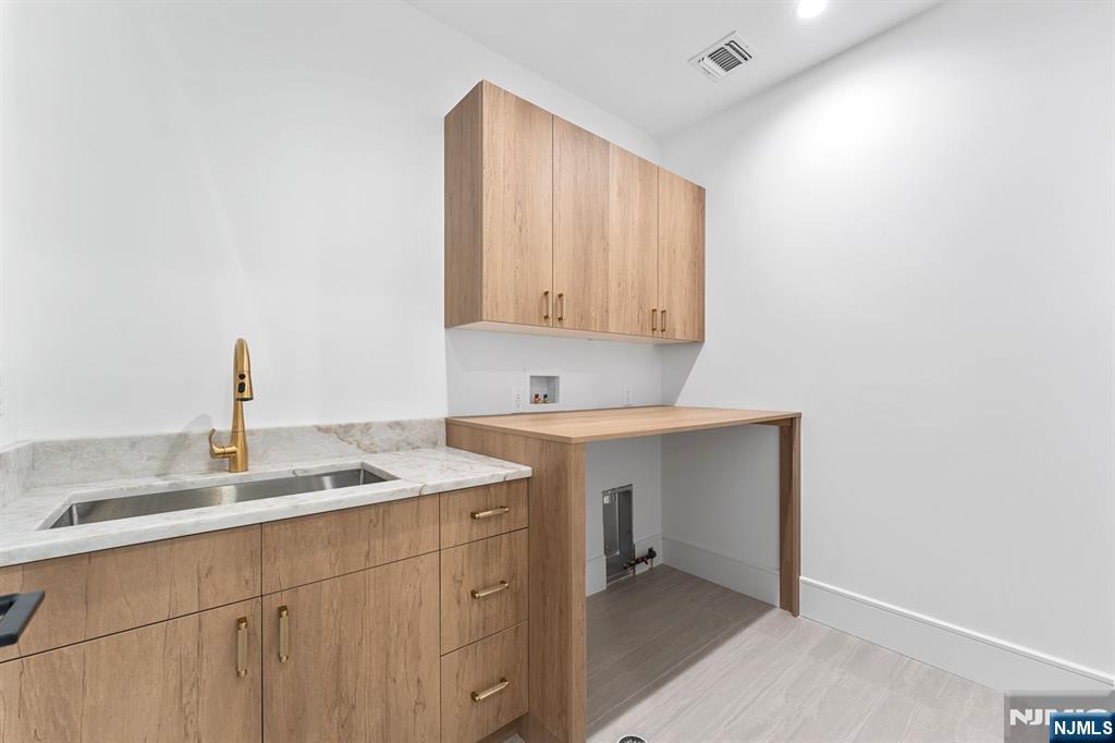 156 Stuart Street Paramus, NJ 07652 - Photo 22 of 47 a bathroom with a sink vanity and mirror