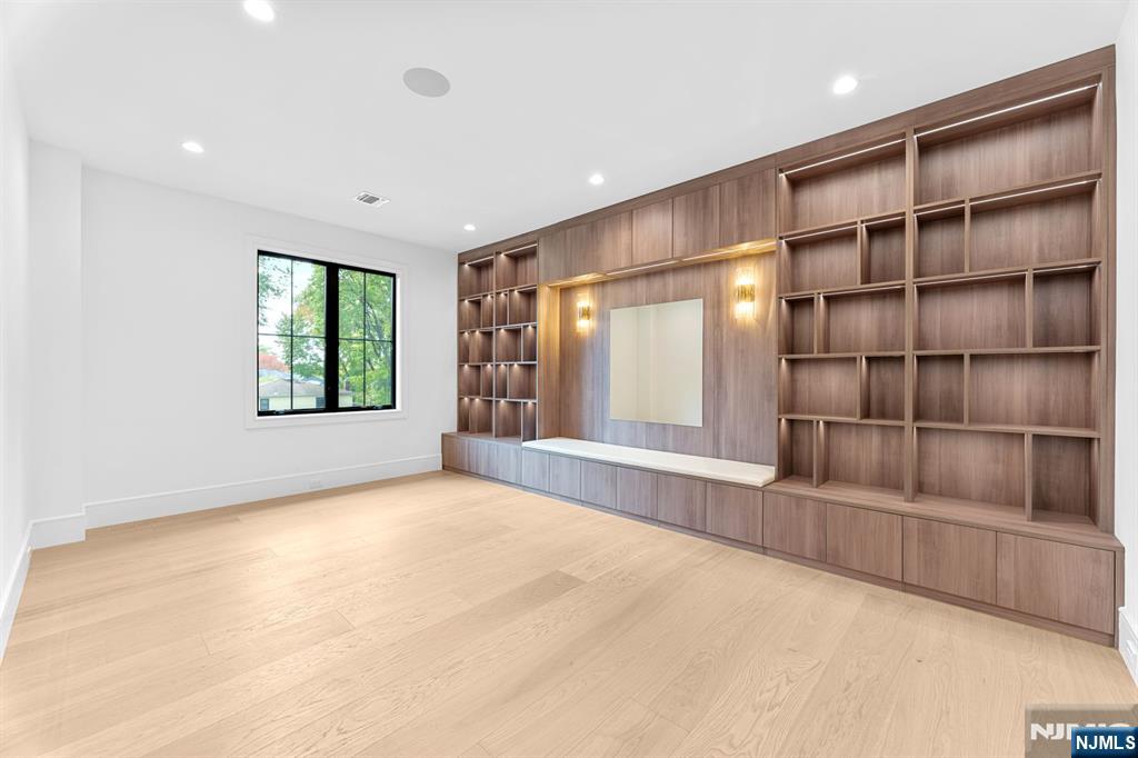 156 Stuart Street Paramus, NJ 07652 - Photo 24 of 47 a view of an empty room with a window and cabinet