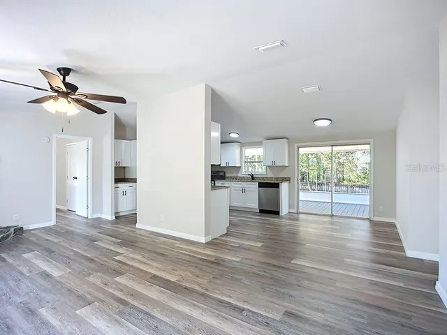 a view of a kitchen with a sink and a window