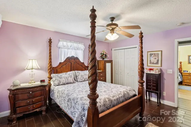 a bedroom with a bed and dresser with mirror