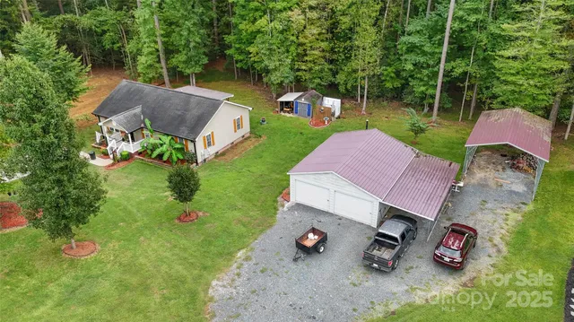 an aerial view of a house with pool garden and a yard