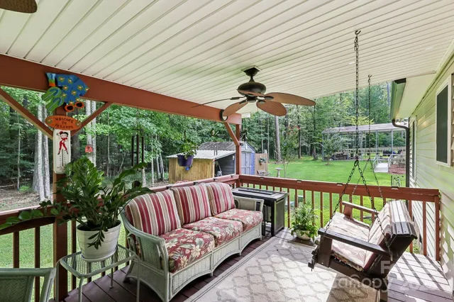 a view of a patio with a table chairs and a backyard