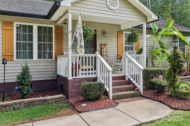 a view of a house with entrance and a garden