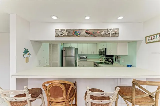 a kitchen with cabinets and stainless steel appliances
