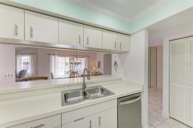a living room with furniture a flat screen tv and kitchen view