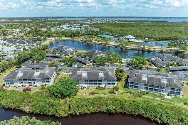 a front view of a house with a garden and palm tree