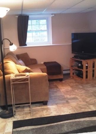 133 Lowell Road Pepperell, MA 01463 - Photo 10 of 19 a living room with furniture and a flat screen tv