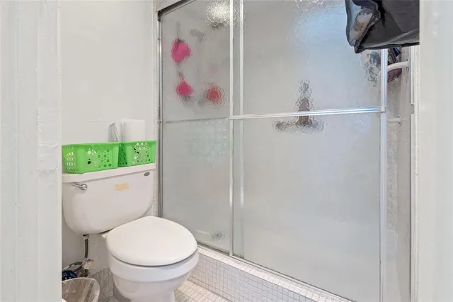 a bathroom with a toilet and a shower