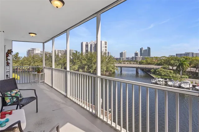 a view of a city from a balcony with furniture