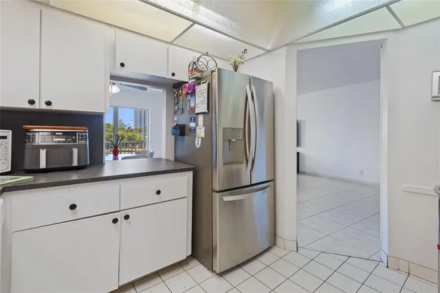 a kitchen with stainless steel appliances granite countertop a refrigerator and a counter top space