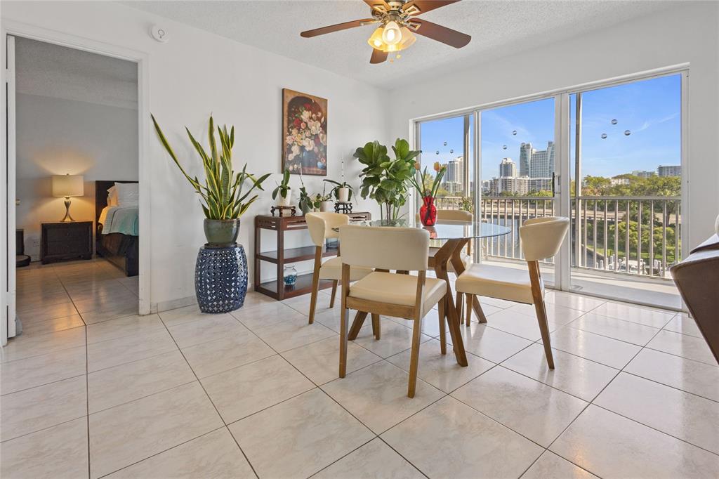 200 Diplomat Parkway, Unit 520 Hallandale Beach, FL 33009 - Photo 6 of 17 a view of a livingroom with furniture and a potted plant