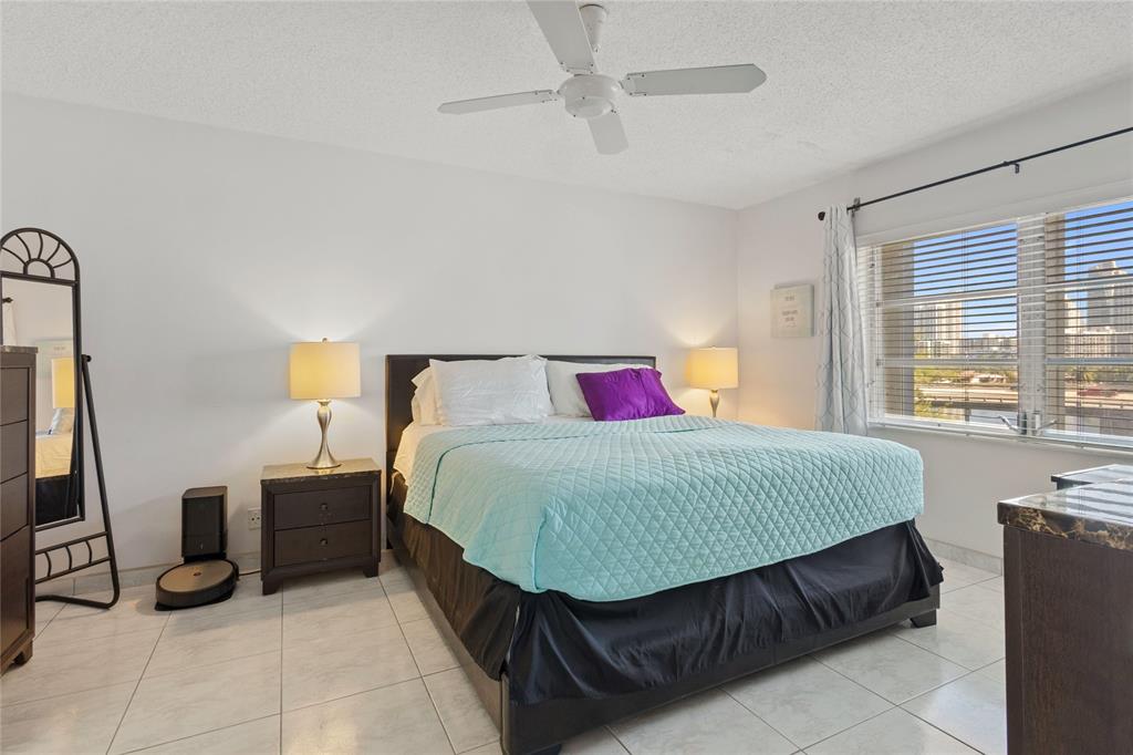 200 Diplomat Parkway, Unit 520 Hallandale Beach, FL 33009 - Photo 7 of 17 a bed sitting in a bedroom next to a window