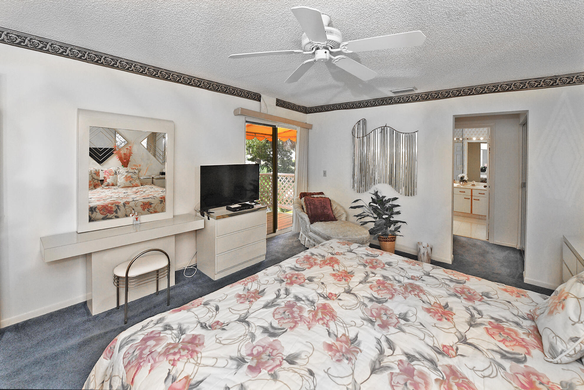 5135 Pointe Alexis Boca Raton, FL 33431 - Photo 23 of 35 a bedroom with a bed and a flat screen tv