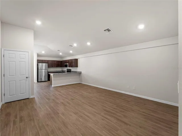 a bathroom with a granite countertop sink a toilet and shower