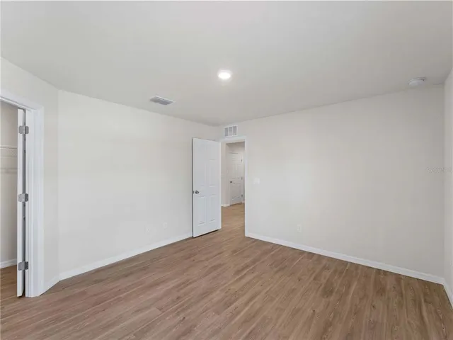 a bedroom with a bed and a television