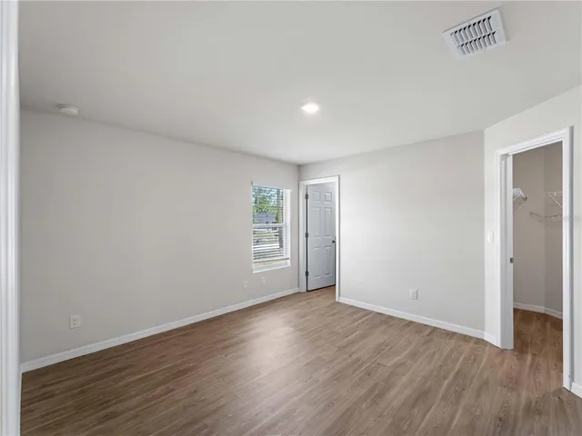 a bedroom with a bed and a flat tv screen