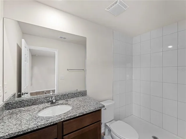 a bedroom with a bed and a tv