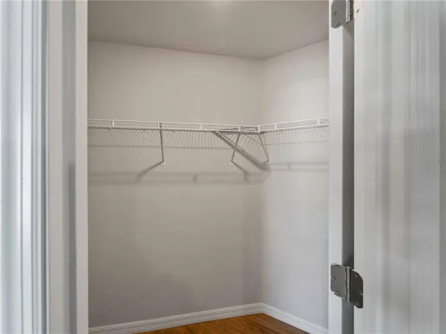 a bathroom with a granite countertop sink vanity mirror and toilet