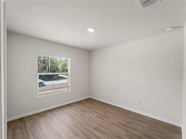 a bathroom with a granite countertop sink toilet and a mirror