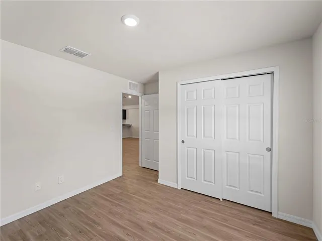 a view of a house with a yard and large tree