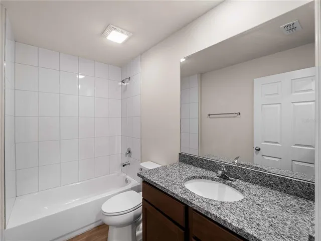 front view of a house with a yard and an trees