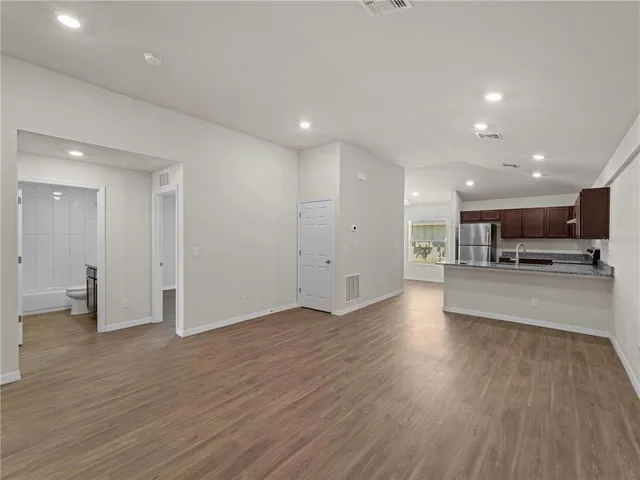 a bathroom with a granite countertop sink a toilet and a mirror