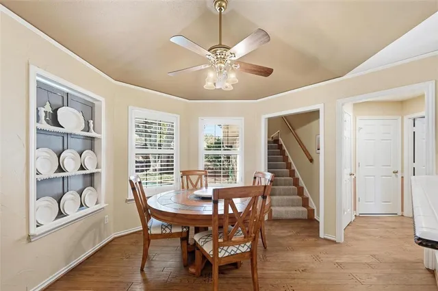 a view of a dining room with furniture wooden floor and chandelier
