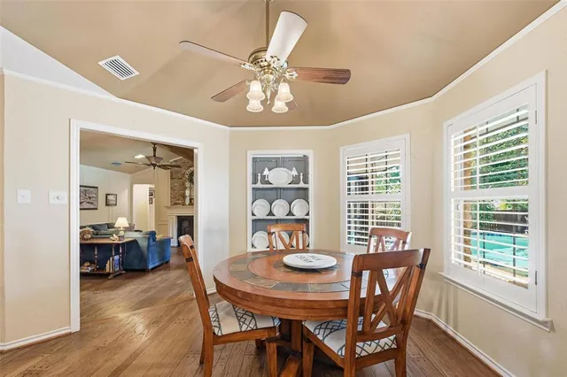 a view of a dining room with furniture and chandelier