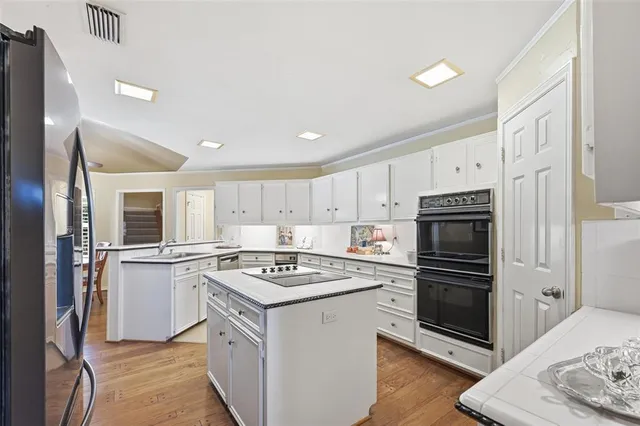 a kitchen with a refrigerator stove and sink