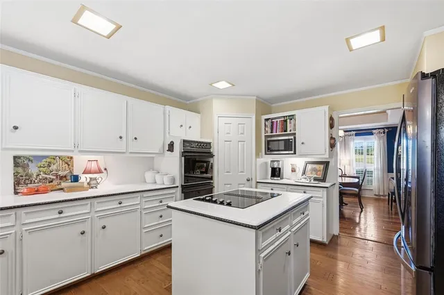 a kitchen with a sink stove and cabinets