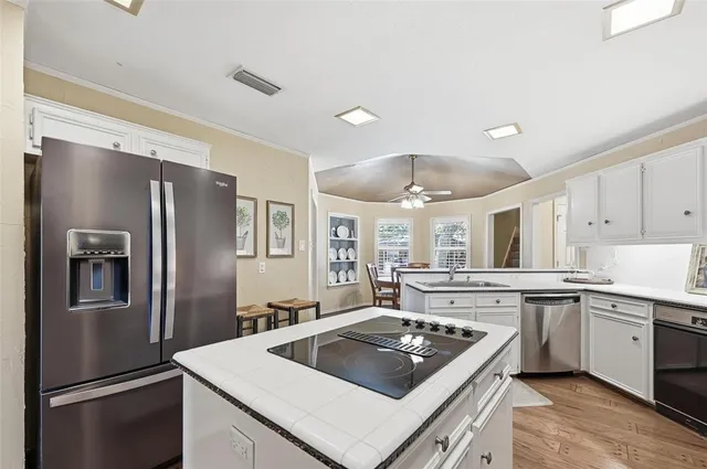 a kitchen with a stove sink and refrigerator