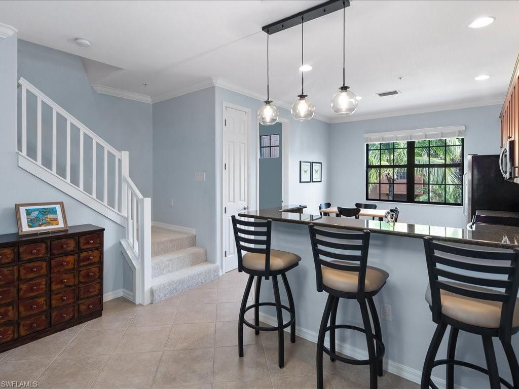 8985 Cambria Circle, Unit 215 Naples, FL 34113 - Photo 11 of 36 a view of a livingroom with furniture and a flat screen tv