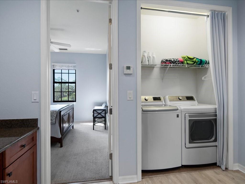 8985 Cambria Circle, Unit 215 Naples, FL 34113 - Photo 17 of 36 a view of utility room and washer and dryer