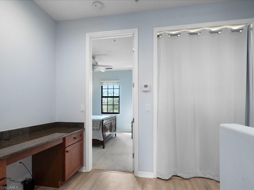 8985 Cambria Circle, Unit 215 Naples, FL 34113 - Photo 18 of 36 a view of a hardwood and an empty room