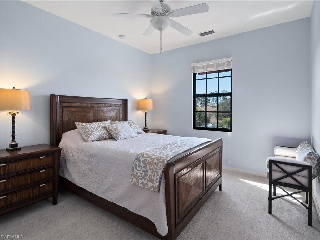 8985 Cambria Circle, Unit 215 Naples, FL 34113 - Photo 20 of 36 a bed room with a bed and a window