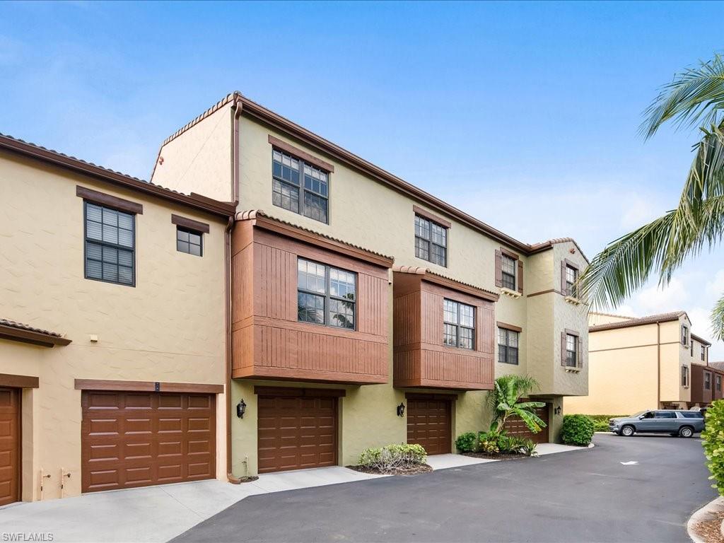 8985 Cambria Circle, Unit 215 Naples, FL 34113 - Photo 26 of 36 a front view of a house with a yard