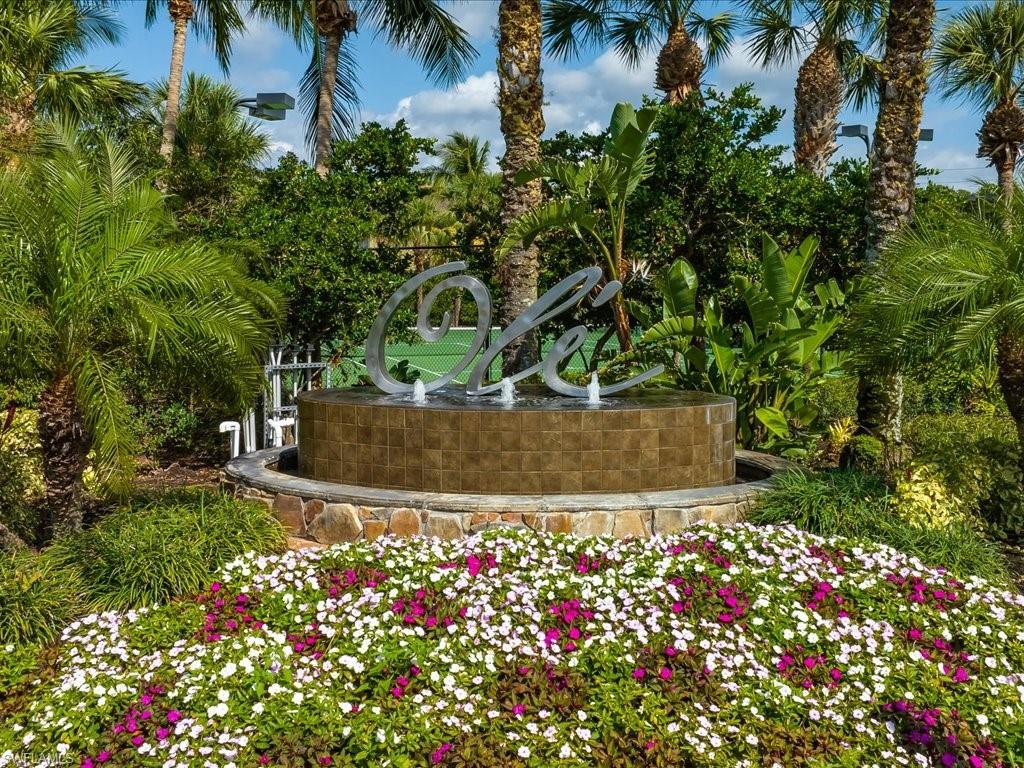 8985 Cambria Circle, Unit 215 Naples, FL 34113 - Photo 27 of 36 front view of a house with a yard