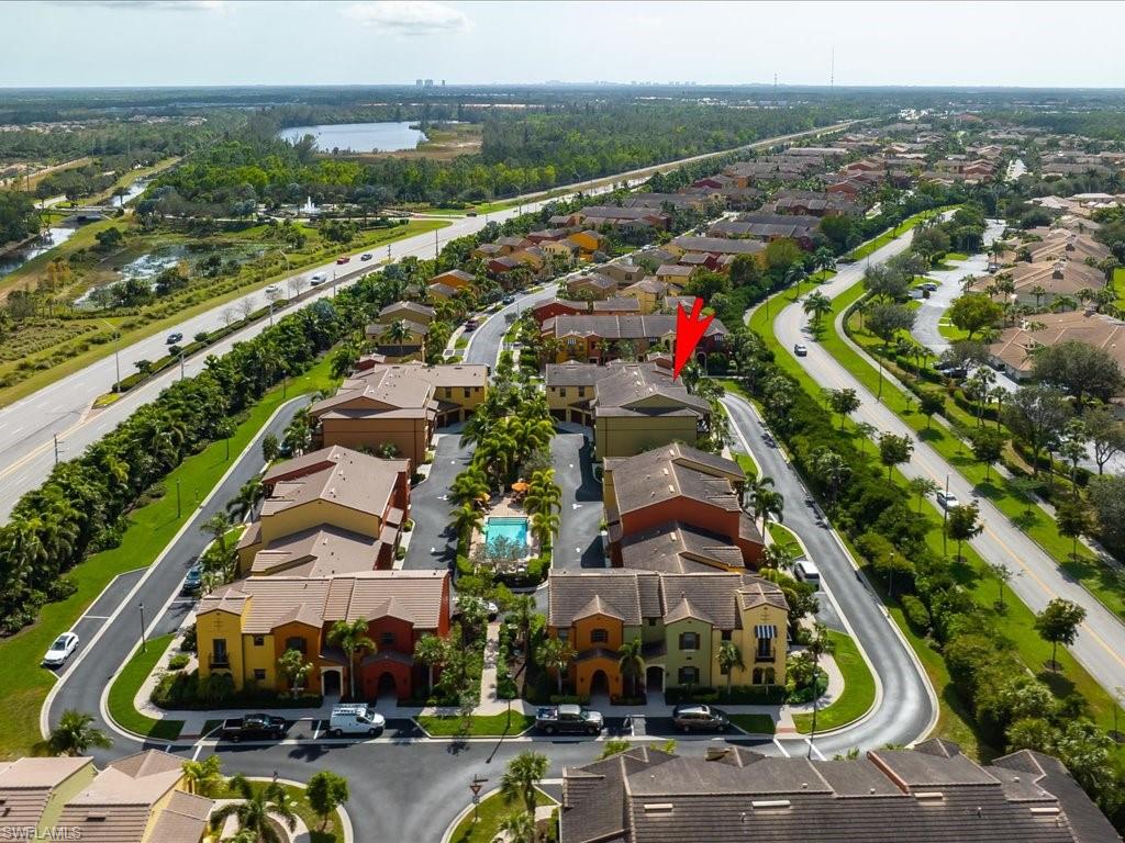 8985 Cambria Circle, Unit 215 Naples, FL 34113 - Photo 30 of 36 an aerial view of residential houses with outdoor space