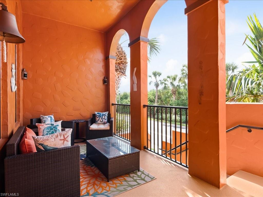 8985 Cambria Circle, Unit 215 Naples, FL 34113 - Photo 3 of 36 a outdoor living room with furniture