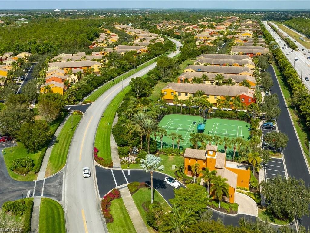 8985 Cambria Circle, Unit 215 Naples, FL 34113 - Photo 34 of 36 an aerial view of residential houses with outdoor space and swimming pool