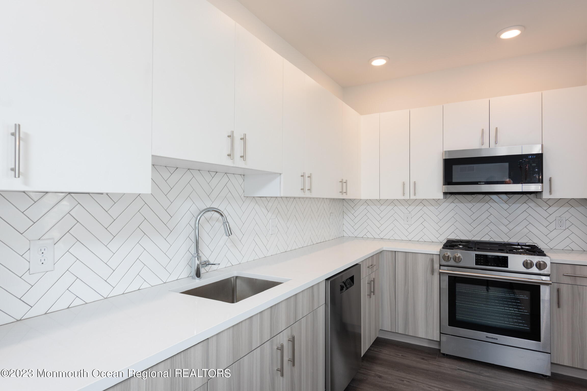 24 Mechanic Street, Unit 208 Red Bank, NJ 07701 - Photo 4 of 17 a kitchen with stainless steel appliances a sink a stove and cabinets