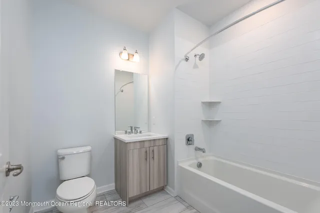 a bathroom with a toilet a sink and bathtub