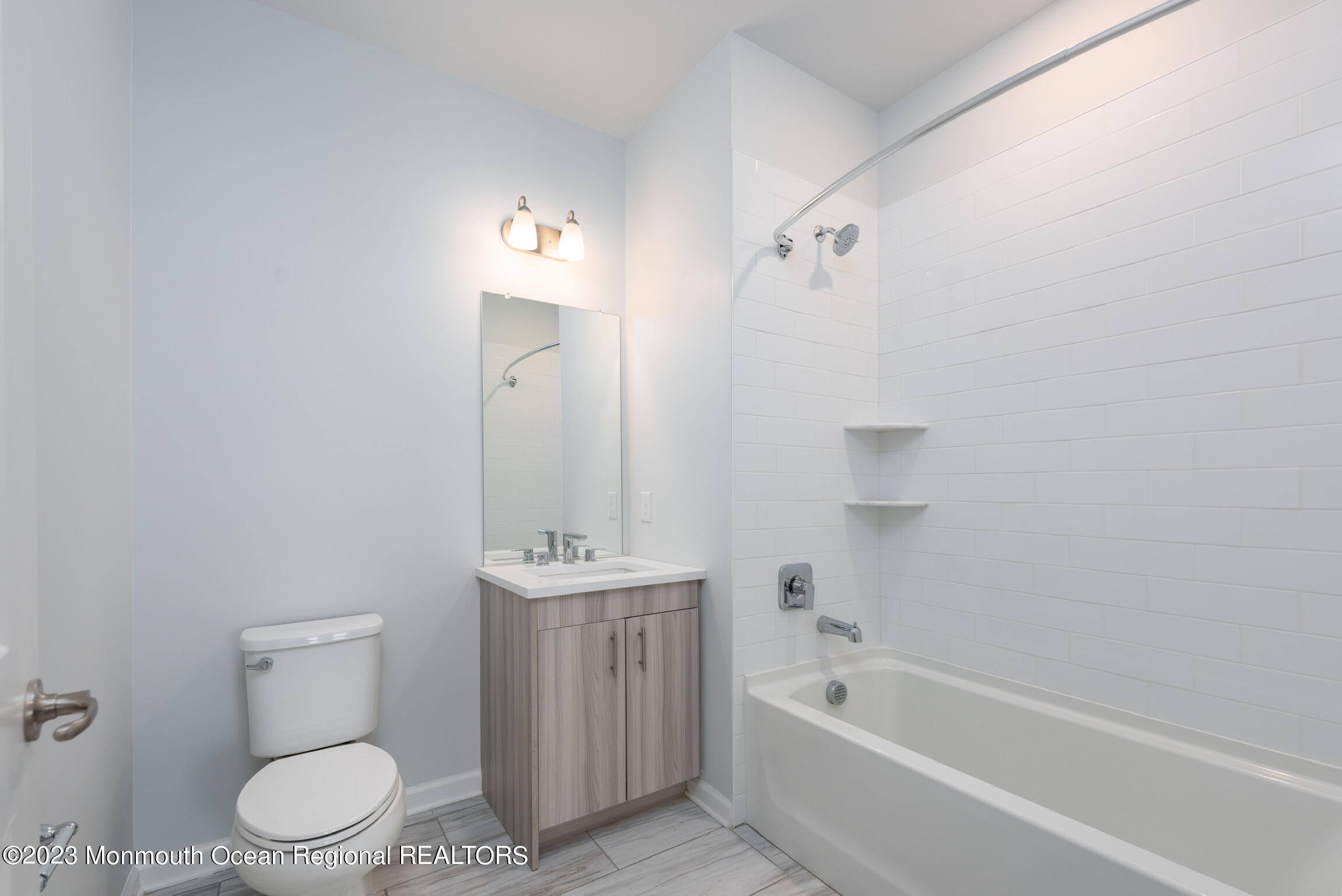 24 Mechanic Street, Unit 208 Red Bank, NJ 07701 - Photo 5 of 17 a bathroom with a toilet a sink and bathtub