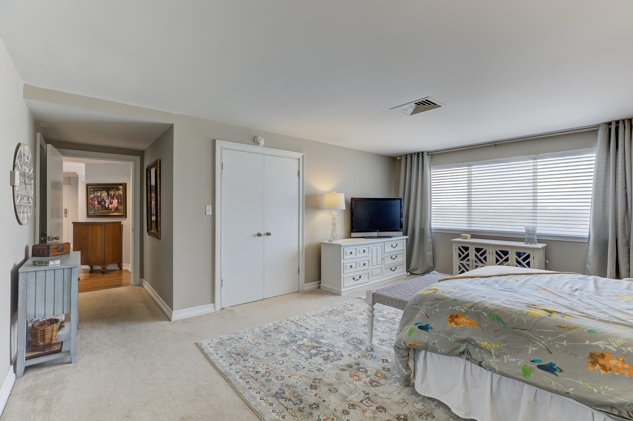 655 Riverside Drive, Unit 506B Memphis, TN 38103 - Photo 13 of 26 a bedroom with a bed and a flat screen television